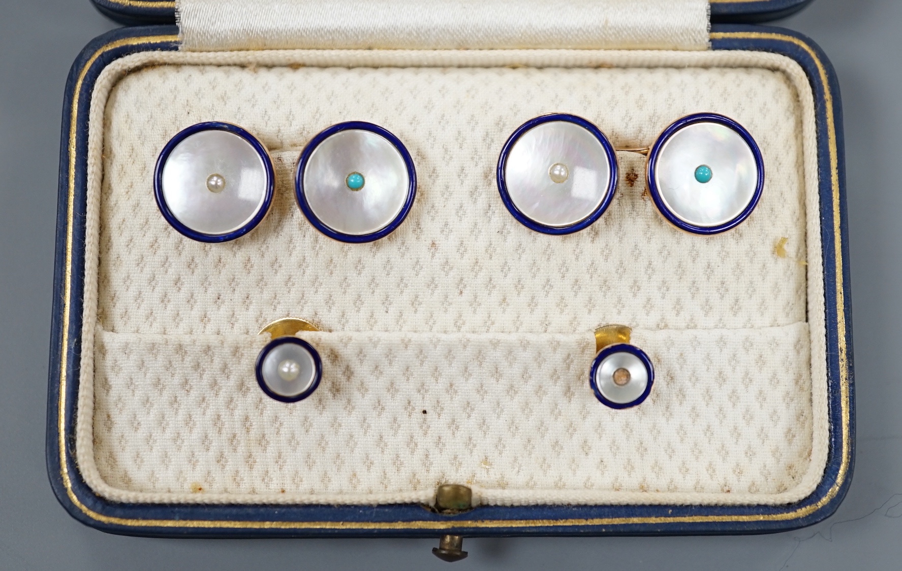 A cased four piece 9ct, mother of pearl turquoise and blue enamel dress stud set, comprising a pair of cufflinks and two studs